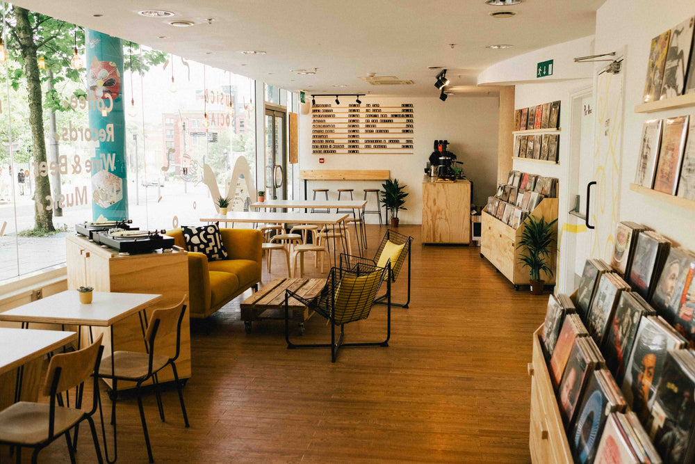 People browsing records and drinking coffee inside 12 Bar, Exeter